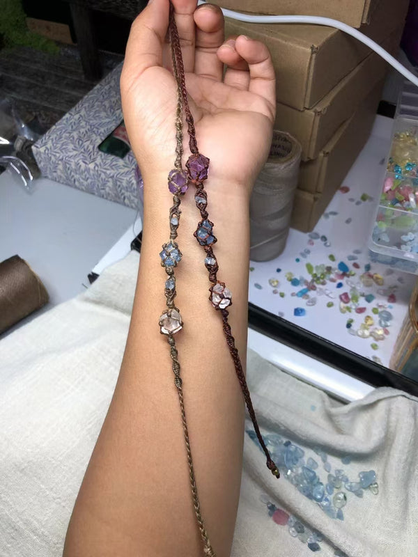 Hand woven bracelet with amethyst, white crystal and aquamarine